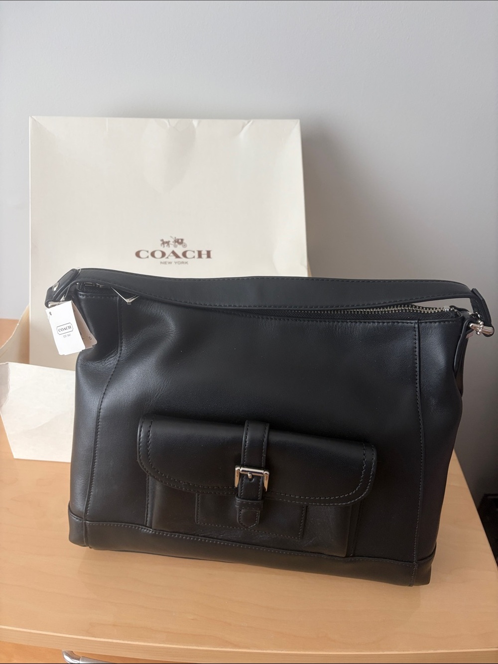 Brand new never used. Coach Black Leather Crossbody Tote with Front Buckle Pock.